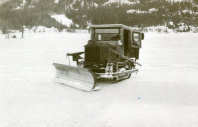 A Tractor Snowplow Crossing the Lake