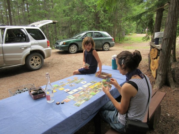 Mateo teaching his sister Azure a Board Game